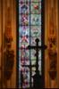 Cologne - Crucifix with stained glass window as a backdrop.